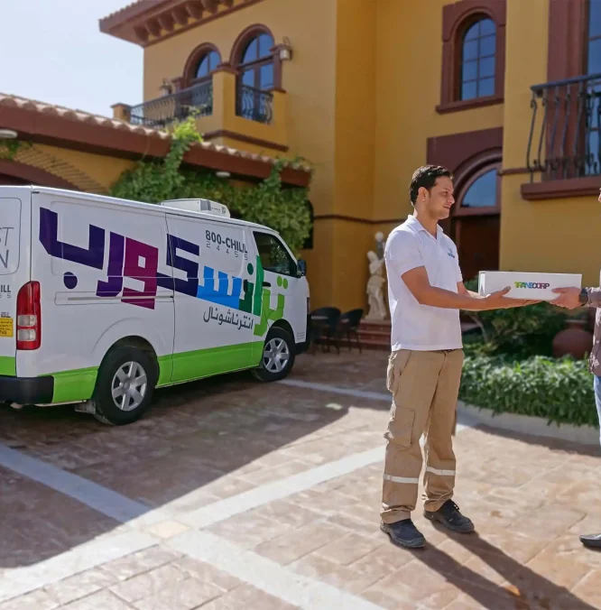 Transcorp driver delivering order in Dubai Transcorp driver handing out the temperature controlled package with the delivery van in the background in Dubai