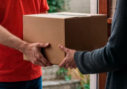 delivery-person-hands-package-woman-her-door (2)
